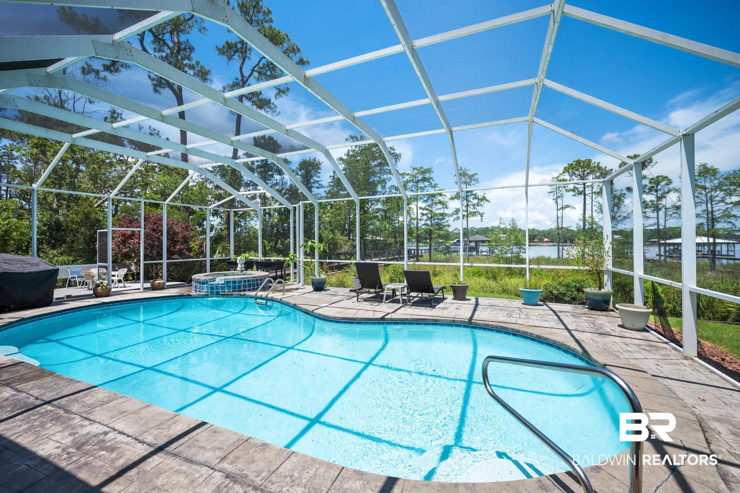 8585 Bay Harbor Road Elberta, AL 36530 - Photo 36 of 51 View of swimming pool featuring a lanai, a patio area, and a pool with connected hot tub