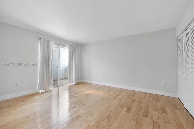 a view of an empty room and wooden floor