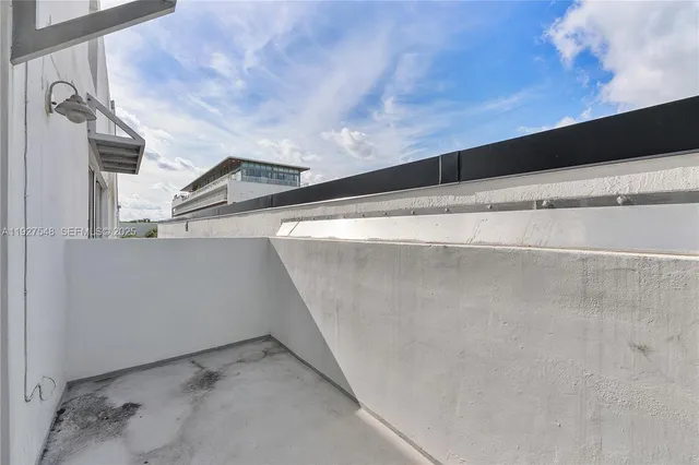 a picture of a bench in front of a white wall