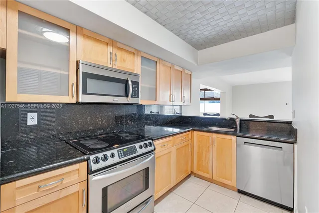 a kitchen with a sink stove and microwave