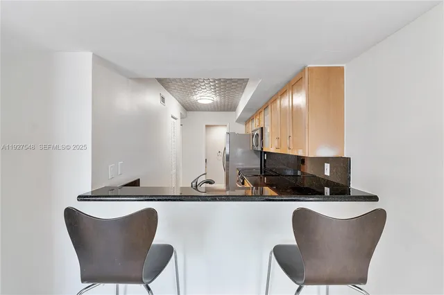 a kitchen with a table chairs a sink and a stove