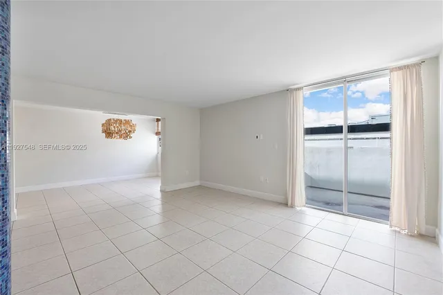 an empty room with cabinet and mirrors