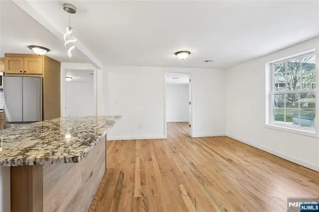 a view of a room with wooden floor and natural light