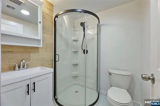 a bathroom with a toilet a sink and shower