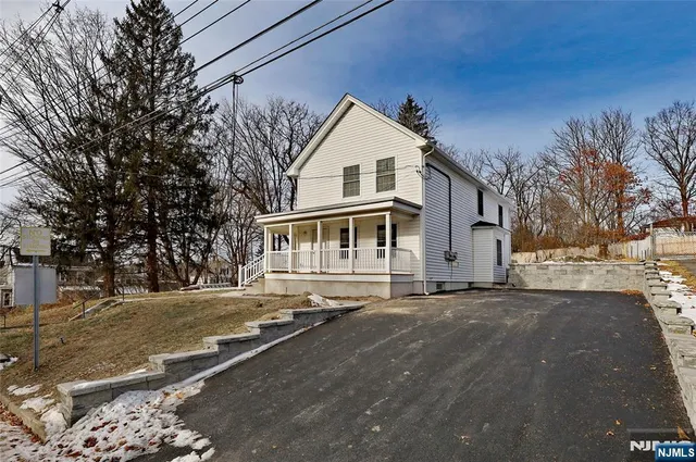 a view of a white house with a yard