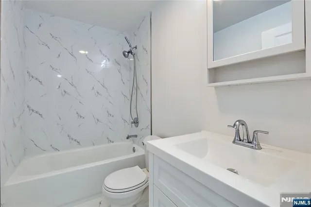 a bathroom with a sink a toilet and a bathtub