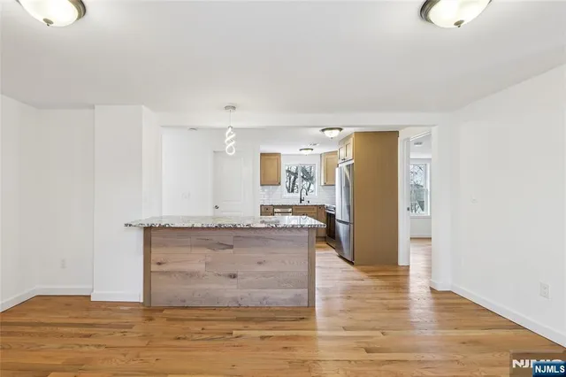 a view of kitchen and hall with wooden floor