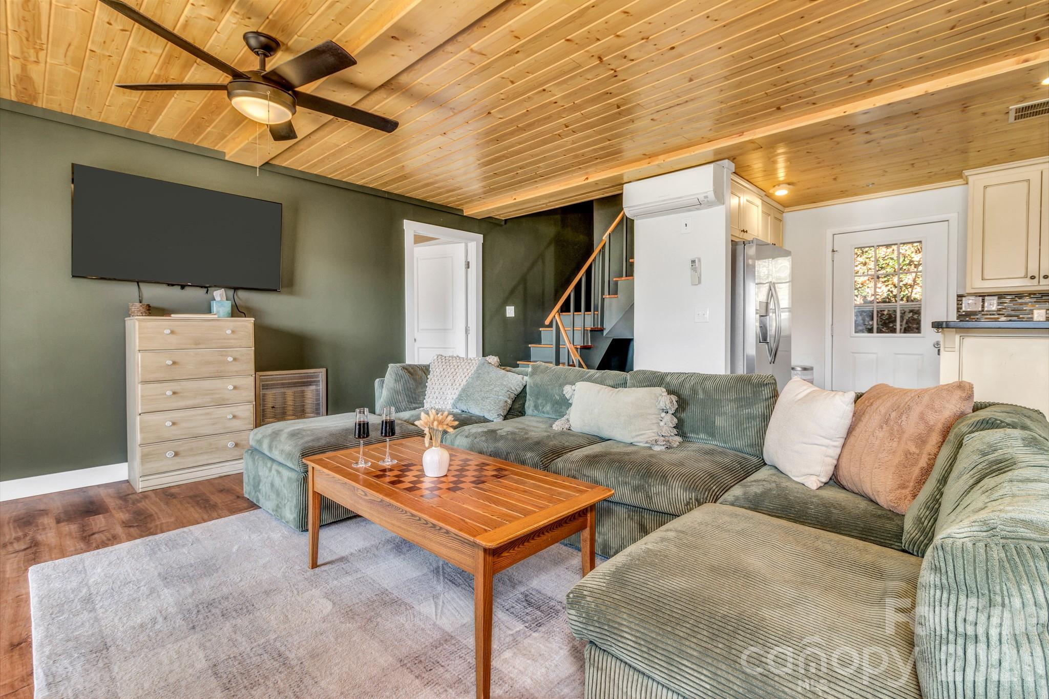 80 Hidden Falls Road Maggie Valley, NC 28751 - Photo 17 of 47 a living room with furniture and a flat screen tv