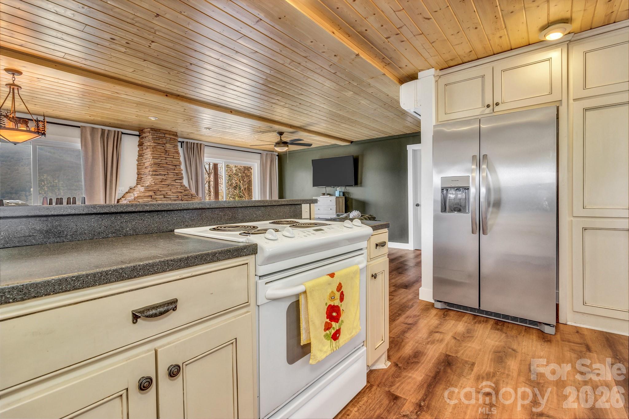 80 Hidden Falls Road Maggie Valley, NC 28751 - Photo 22 of 47 a kitchen with stainless steel appliances granite countertop a sink and cabinets