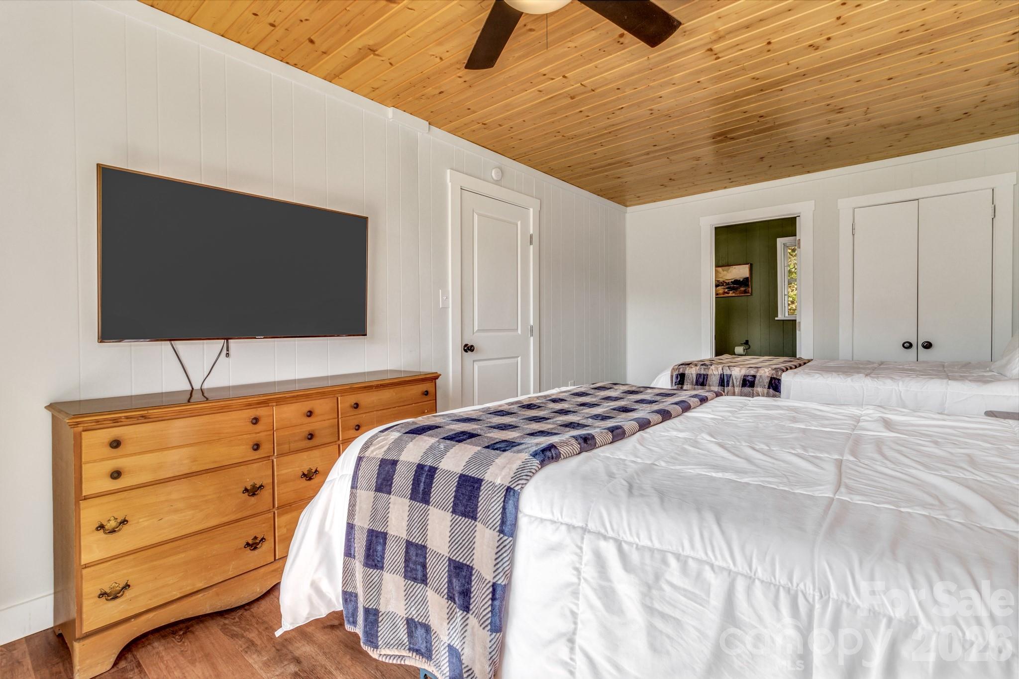 80 Hidden Falls Road Maggie Valley, NC 28751 - Photo 26 of 47 a bedroom with a bed and a flat tv screen on dresser