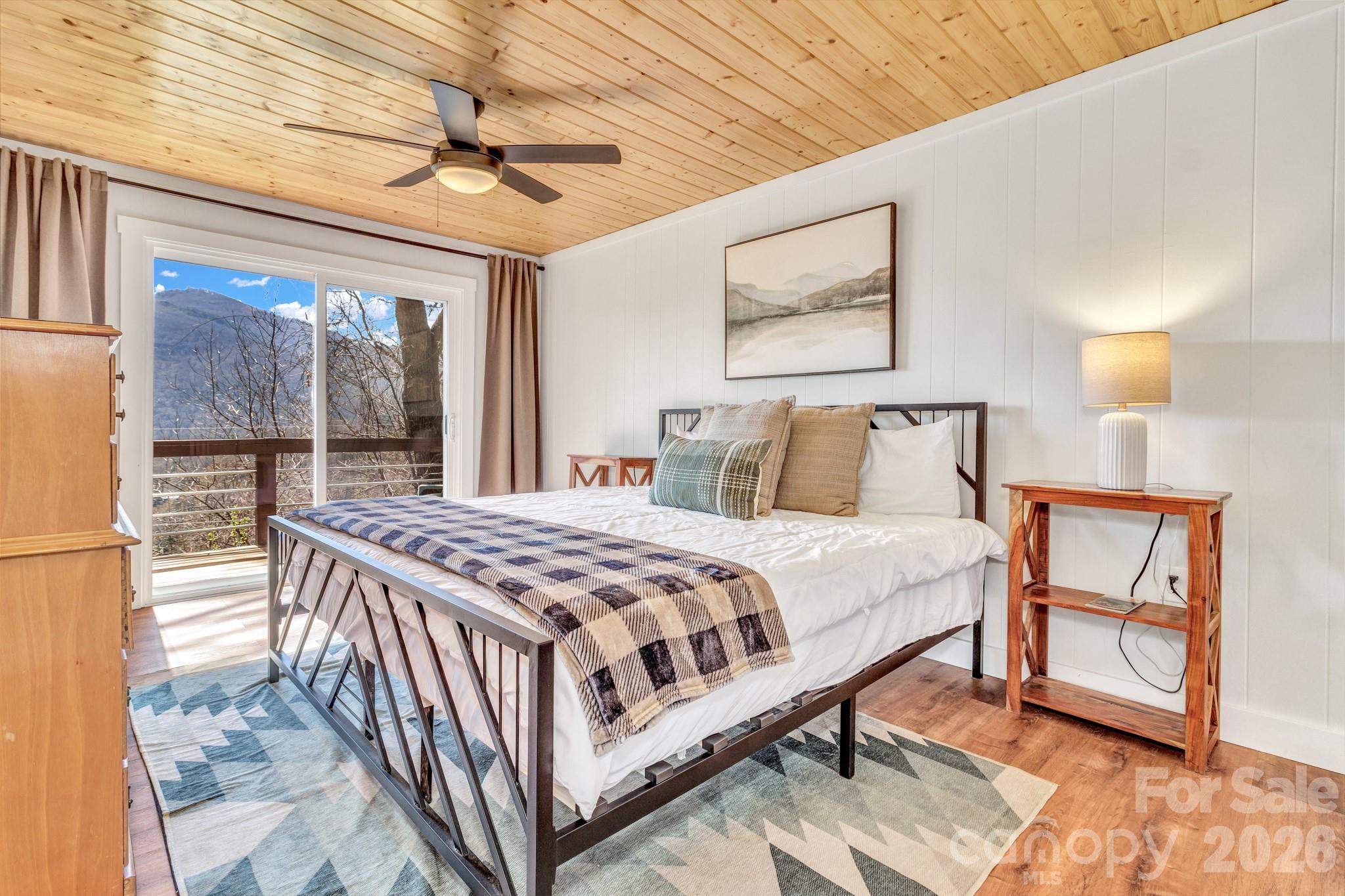 80 Hidden Falls Road Maggie Valley, NC 28751 - Photo 29 of 47 a bedroom with a bed and a table