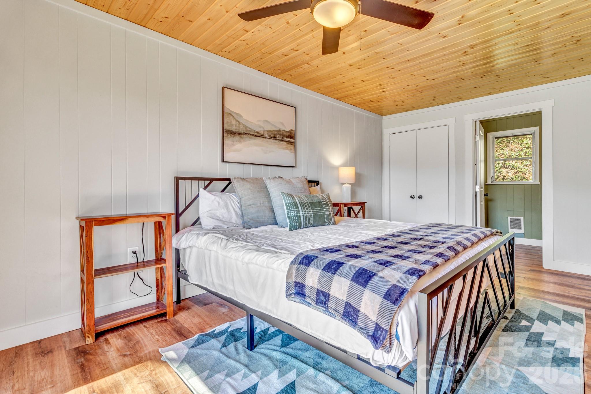 80 Hidden Falls Road Maggie Valley, NC 28751 - Photo 30 of 47 a bedroom with a bed and wooden floor