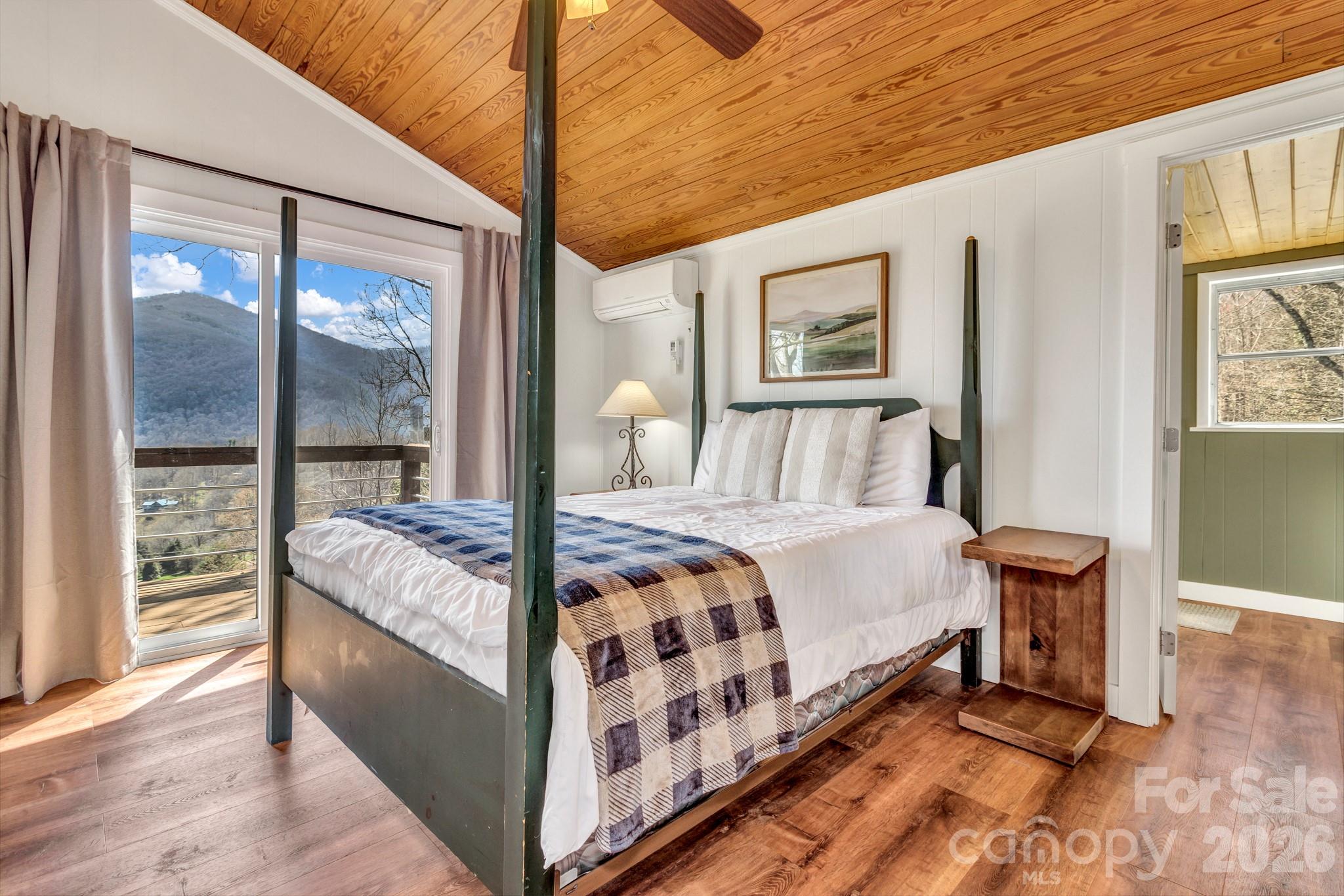 80 Hidden Falls Road Maggie Valley, NC 28751 - Photo 36 of 47 a bedroom with a large bed and a large window