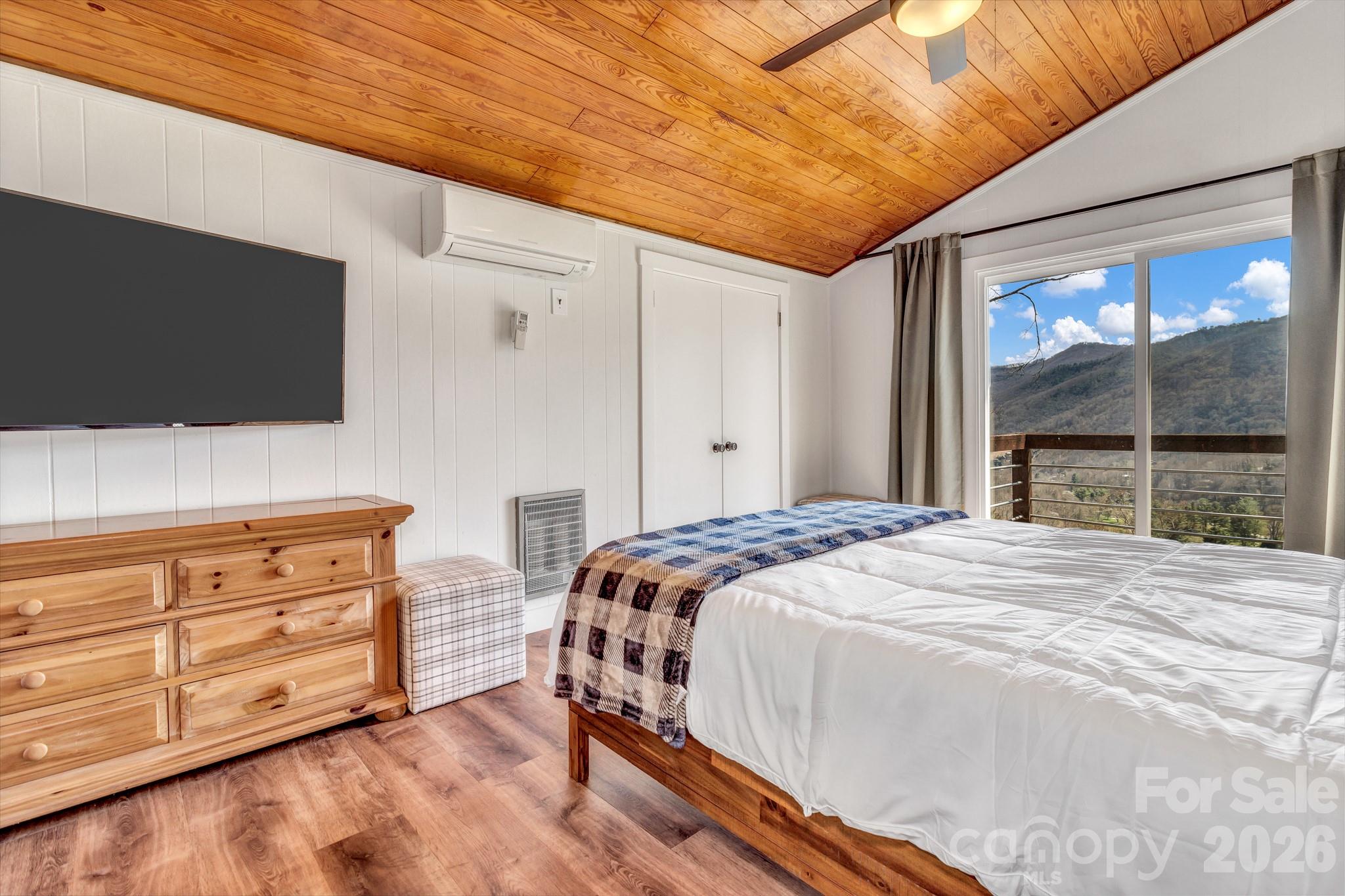 80 Hidden Falls Road Maggie Valley, NC 28751 - Photo 40 of 47 a bedroom with a bed and a flat tv screen on dresser