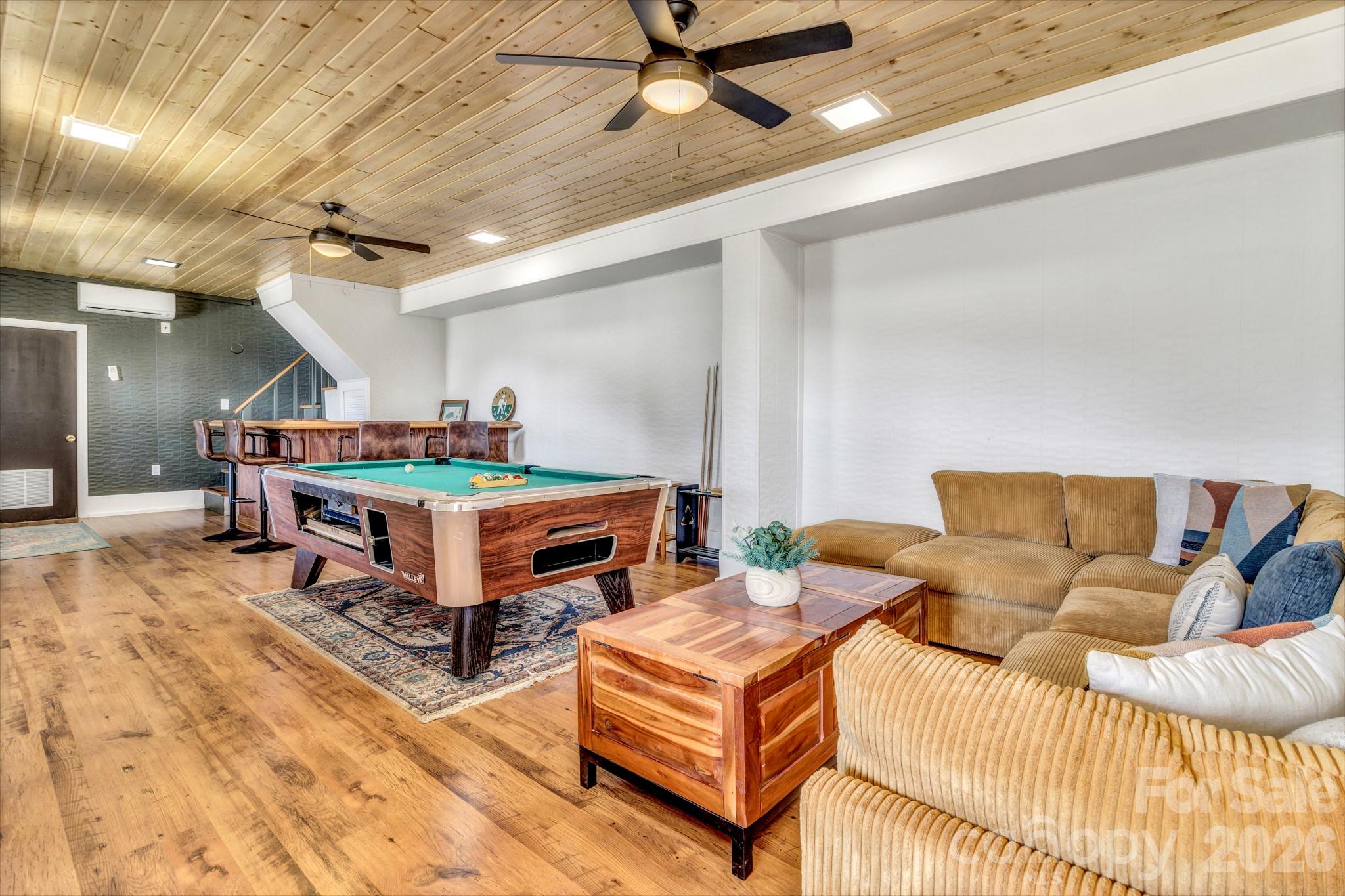 80 Hidden Falls Road Maggie Valley, NC 28751 - Photo 10 of 47 a living room with furniture and a wooden floor