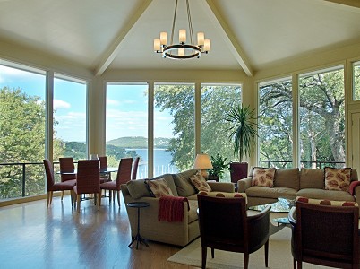 a living room with furniture and floor to ceiling windows
