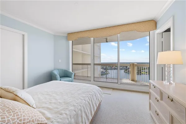 a bedroom with a large bed and a large window