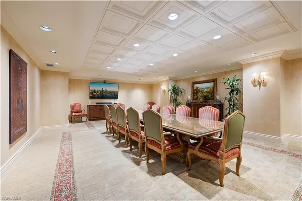 a dining room with furniture and a book shelf