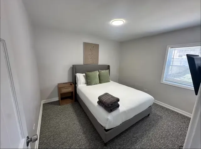 a bedroom with a bed and window