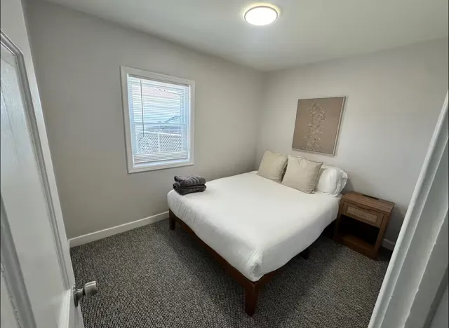 a bedroom with a bed and a window