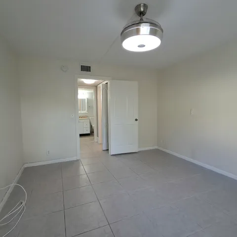 a view of an empty room with a bathroom
