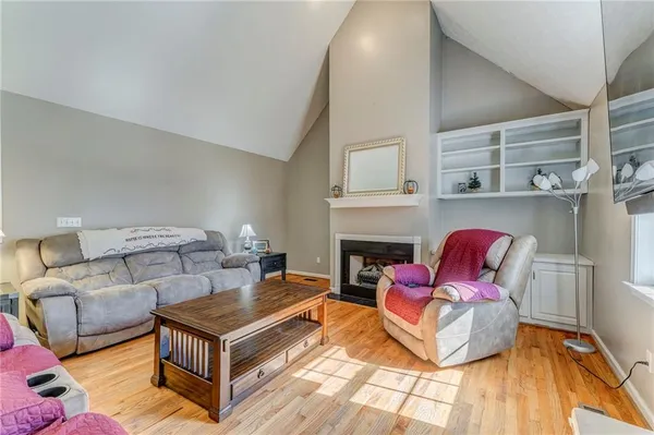 a living room with furniture a fireplace and a table