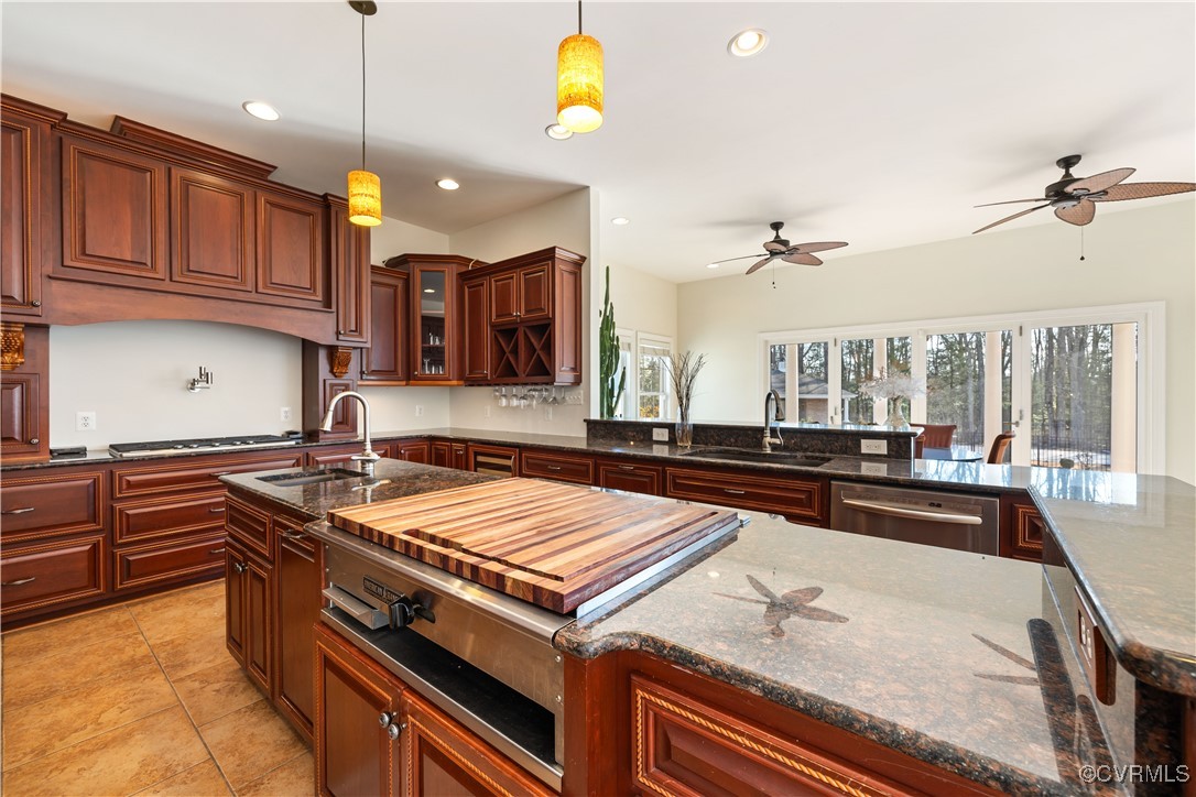 18185 Narrow Path Trail Doswell, VA 23047 - Photo 16 of 48 a kitchen with stainless steel appliances granite countertop a sink a stove and a wooden cabinets
