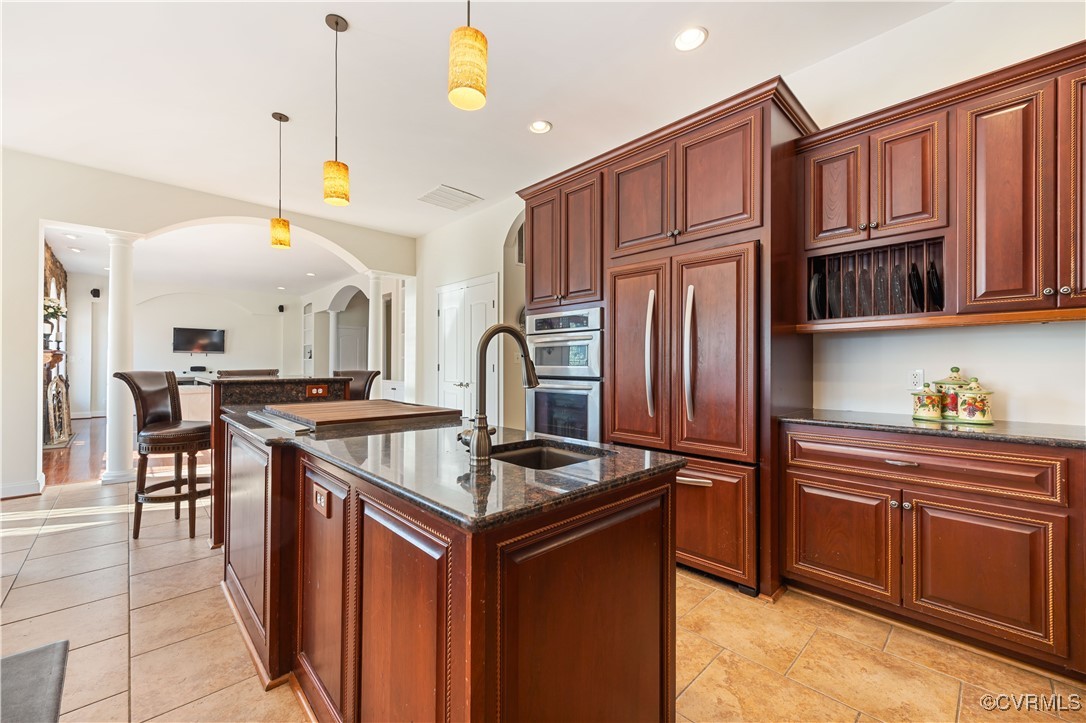 18185 Narrow Path Trail Doswell, VA 23047 - Photo 19 of 48 a kitchen with stainless steel appliances granite countertop a stove and a refrigerator