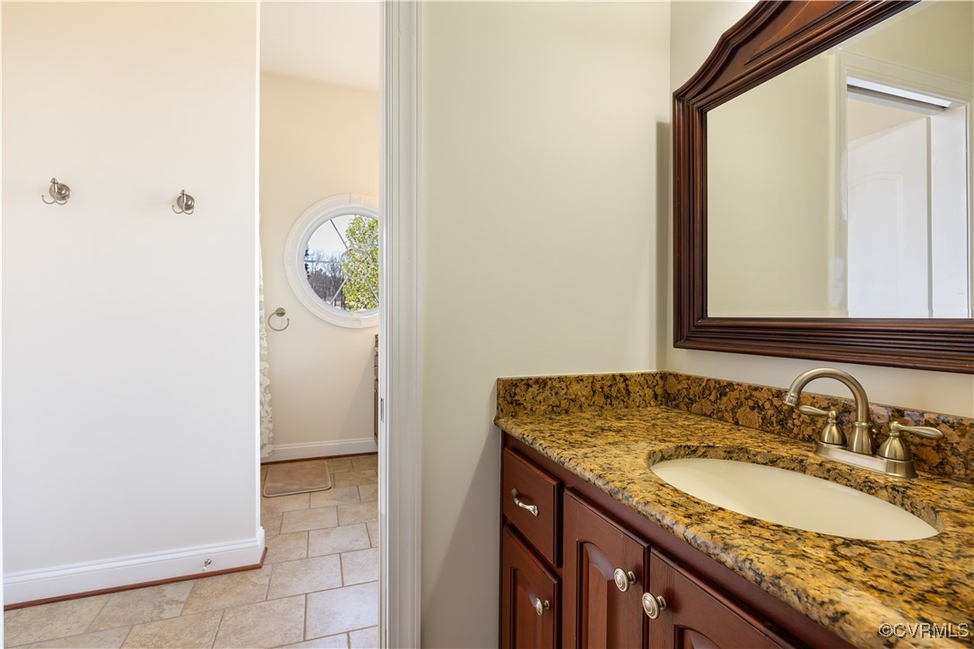 18185 Narrow Path Trail Doswell, VA 23047 - Photo 32 of 48 a bathroom with a granite countertop sink and a mirror