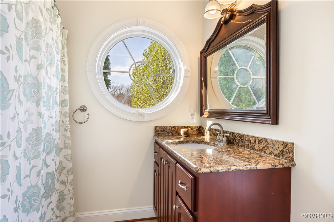 18185 Narrow Path Trail Doswell, VA 23047 - Photo 33 of 48 a bathroom with a granite countertop toilet a sink and a mirror