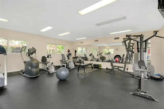 a outdoor space with lots of tables a chair and a fireplace