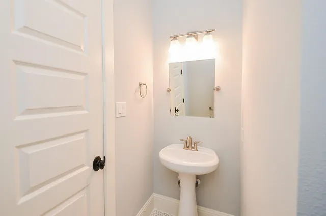 a bathroom with a sink and mirror