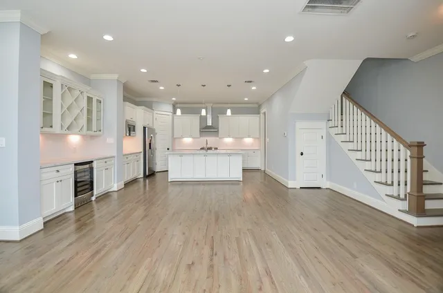a view of kitchen with wooden floor and electronic appliances