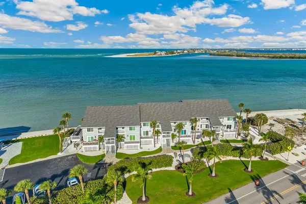 an aerial view of a house with a garden and lake view