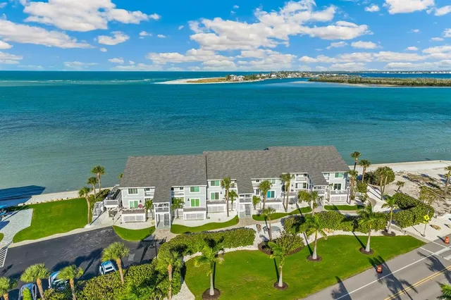 an aerial view of a house with a garden and lake view