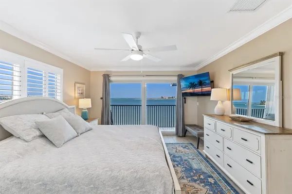 a bedroom with two beds and a large window