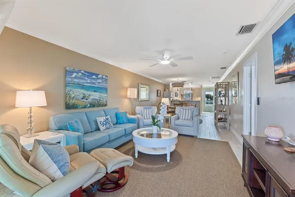 a room with furniture a rug a lamp and a window