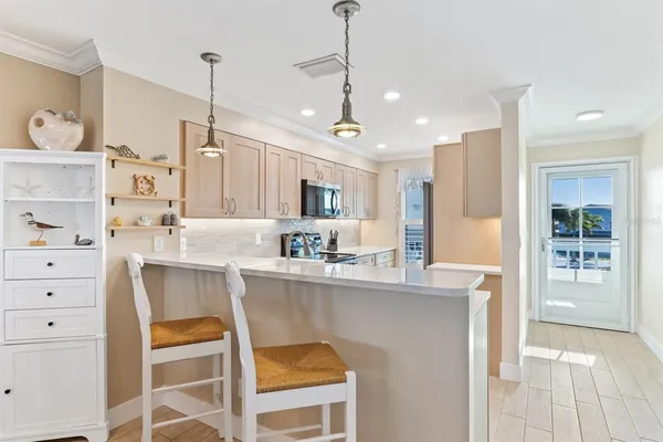 a kitchen with appliances a sink and cabinets