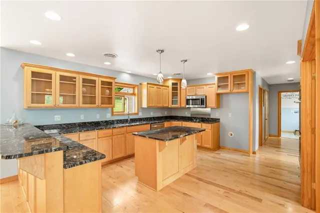 a kitchen with stainless steel appliances granite countertop a sink and cabinets