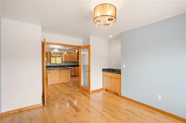 a view of a room with wooden floor and a ceiling fan