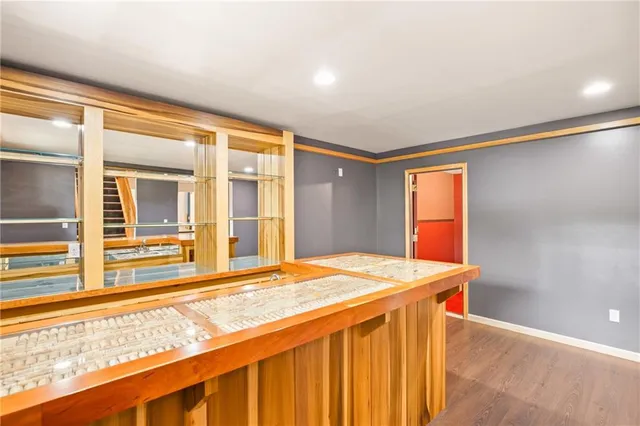 a bedroom with a bed and a dresser next to a window