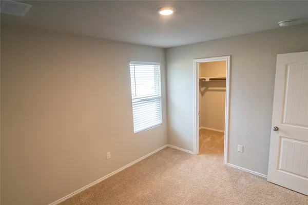 an empty room with windows and closet