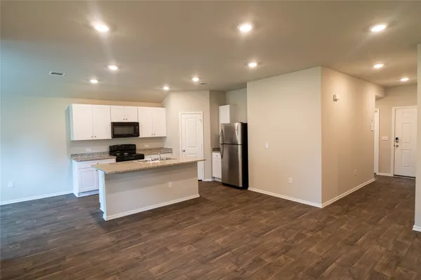a view of kitchen with stainless steel appliances refrigerator oven and microwave