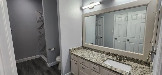 a view of a room with wooden floor