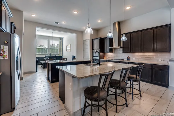 a kitchen with granite countertop a sink and cabinets