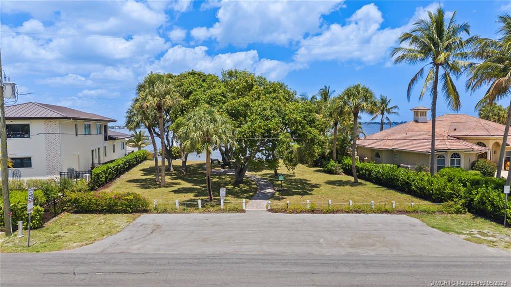818 Southeast Riverside Drive Stuart, FL 34994 - Photo 7 of 12 a view of a house with a yard and potted plants