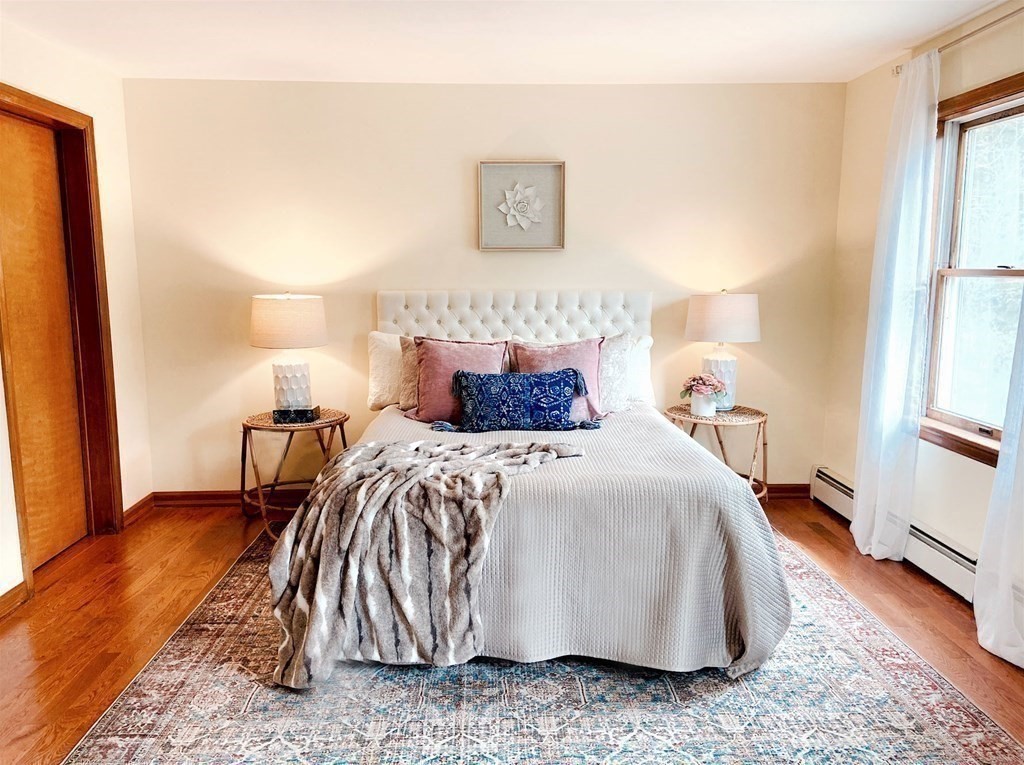 258 Old Warren Road Palmer, MA 01069 - Photo 13 of 24 a bedroom with a bed and wooden floor