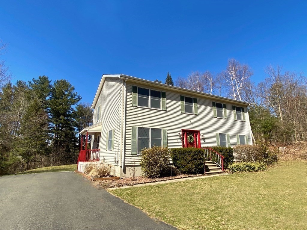 258 Old Warren Road Palmer, MA 01069 - Photo 2 of 24 a front view of a house with a yard