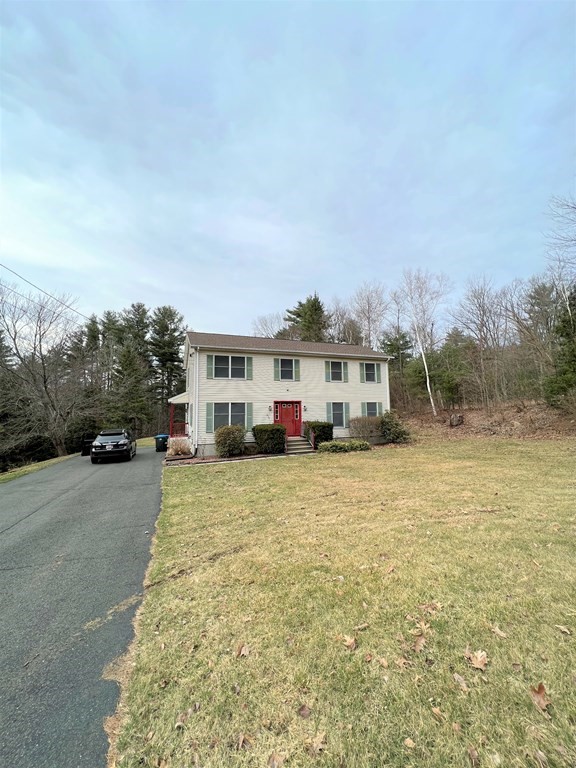 258 Old Warren Road Palmer, MA 01069 - Photo 24 of 24 a front view of a house with a yard and trees