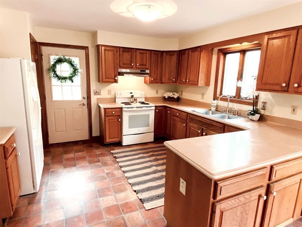 258 Old Warren Road Palmer, MA 01069 - Photo 7 of 24 a kitchen with a refrigerator stove top oven and sink